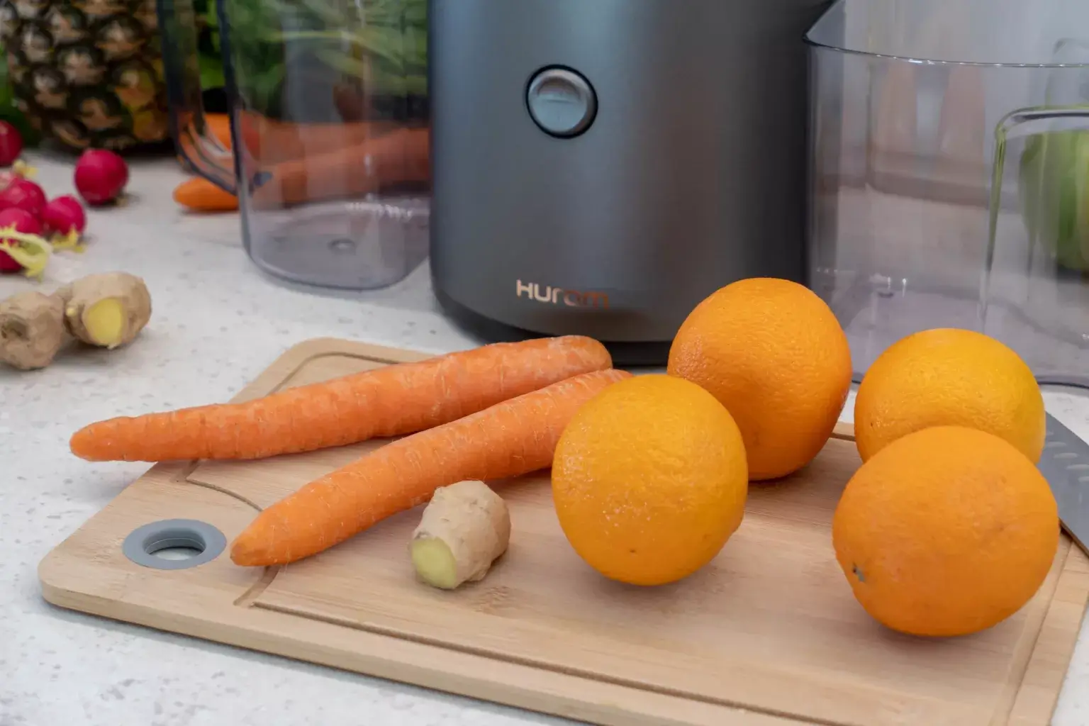 Carrot, Ginger & Orange in front of Hurom H320N slow juicer
