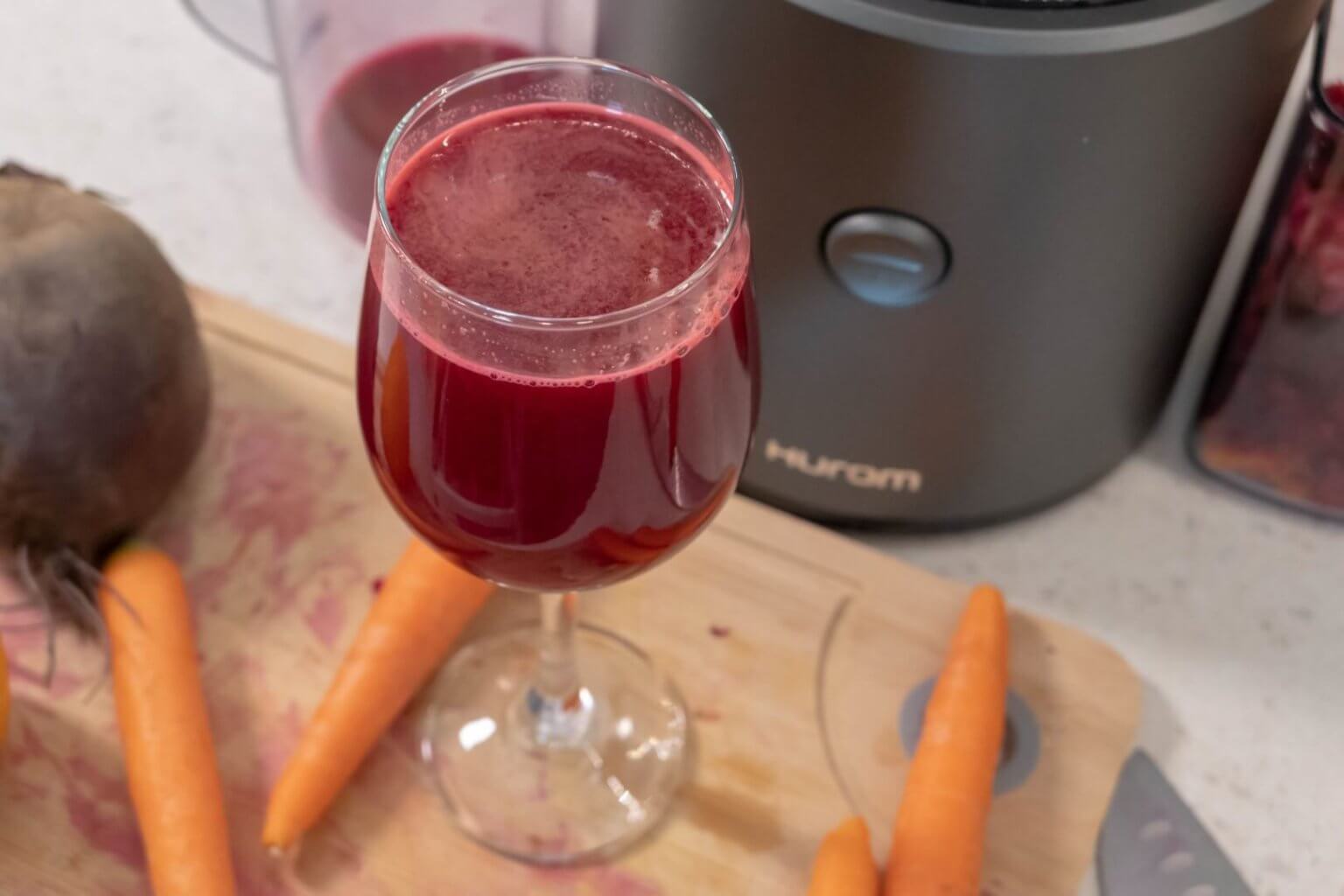 Ginger, Orange, Beetroot and Carrots - cold pressed juice in a glass